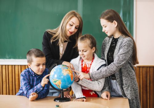 Professora ensinando alunos em sala de aula antes de receber mensagem do dia dos professores