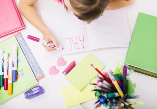 Aluna escrevendo utilizando seu aprendizado de alfabetização e letramento