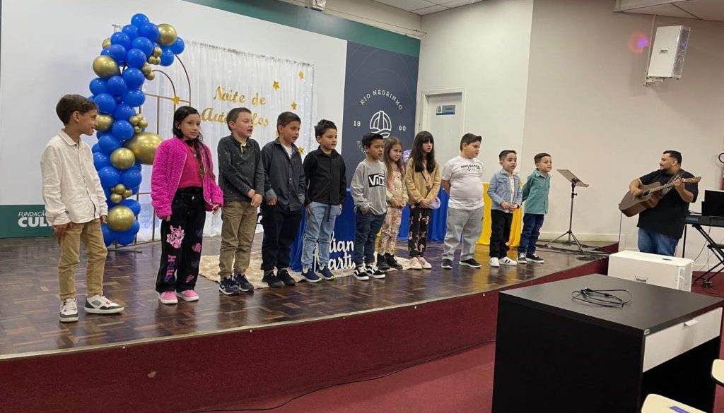 Crianças no palco em Evento de Autógrafos feito em parceria com a Estante Mágica.